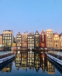Reflection over Damrak Canal in Amsterdam Netherlands 