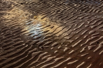 Reflections on sand ripples - Llanfairfechan Beach North Wales UK Sun producing almost a rainbow effect  x OC