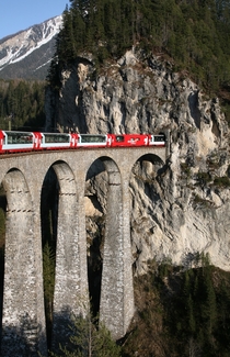 Rhaetian Railway Glacier Express on the Landwasser Viaduct entering the Landwasser tunnel 