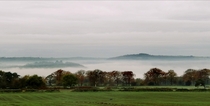 Riber Castle floating amongst the clouds on a misty morning in the peak district  x