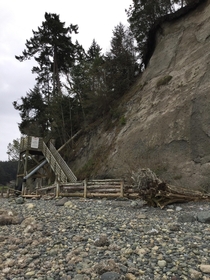 rotting beach stairs the house was damaged in a mudslide and the property was abandoned even the concrete holding it up is beginning to chip away