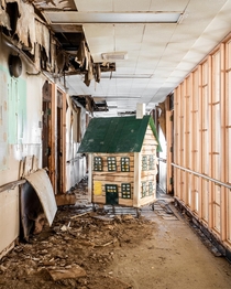 Rotting playhouse left in the hallway of an abandoned psychiatric center in Kentucky 