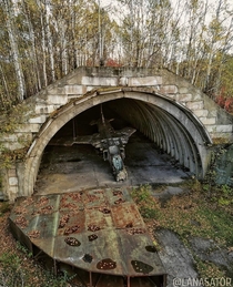 Rusting Mig- Soviet combat aircraft in its shelter near Komsomolsk-on-Amur
