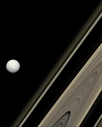 Saturns rings and moon Tethys -- by Cassini spacecraft