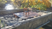 Saw the chair on a small abandoned bridge