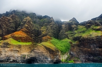 Seaside caves under foggy cliffs Kauai HI 