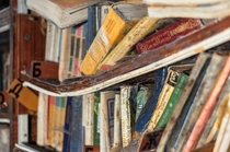 Shelf with books in an abandoned library 