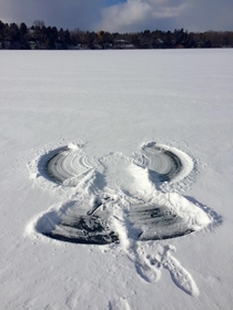 Snow angel on a frozen lake
