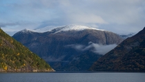 Snow covered mountain in the fjord - Hardanger Western Norway 