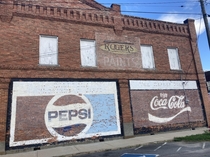 Some advertisements on the wall of an old building