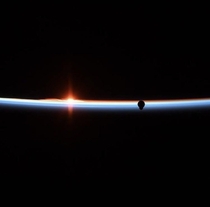 SpaceXs Crew Dragon as it approaches the horizon captured from the ISS