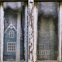Spotted this dollhouse sitting in the window of an abandoned Victorian home