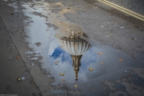 St Pauls Cathedral in London reflected in a puddle  Photographed by Sara Melhuish