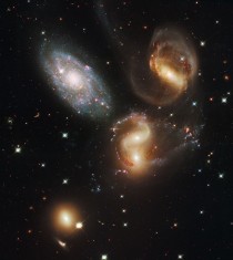 Stephans Quintet as captured by Hubble Comprised of NGC A and B NGC  and NGC  The little guy in the left hand corner is NGC  He doesnt belong in the quintet but this is the best photo I could find 