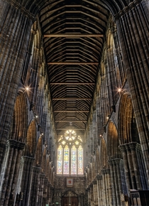 Stone arches wood roof stained glass window of Glasgow Cathedral 