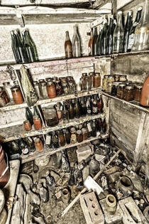 Storeroom full of jams preserves and homemade wine in the dank basement of an abandoned house in Hamilton ON Canada