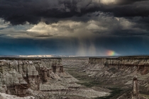Storm clouds and a small rainbow over Coal Mine Canyon 