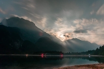 Stunning moonlight behind the clouds in Predil Lake TarvisioItaly 