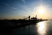 Sunrise over the industrial harbour Rotterdam Netherlands 