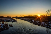 Sunset over a freshly unfrozen creek Sherburne national wildlife refuge 