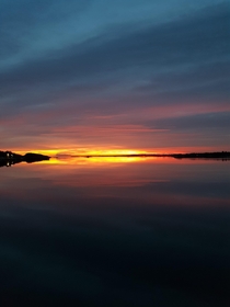Sunset over windstill ocean in Sweden