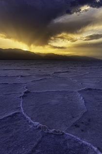 Sunset under a raincloud at Badwater Basin Death Valley 