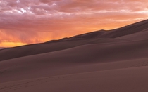 Sunset with rain over the Great Sand Dunes National Park in Colorado 