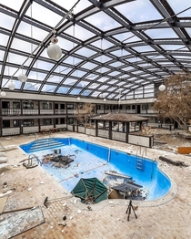 Swimming pool in the middle of an abandoned hotel
