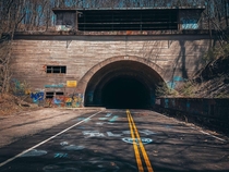 The abandoned PA Turnpike A whole  miles of forgotten road with  long tunnels along the way now converted to a Rails to Trails Video link in the comments