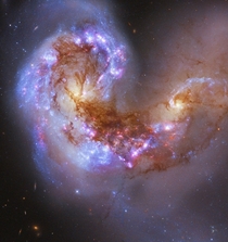 The Antennae Galaxies - Two Spiral Galaxies Merging to Become One Single Elliptical Galaxy 