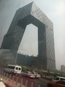The China Central Television Building Beijing China Id like to have taken a better picture but this was as good as I could get in the time it took for me to notice that I was coming up on it and then take a picture as I was driving by on a bus