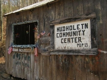 The ghost town of Mudhole TN has a community center that is decorated for every season Largely abandoned during the Great Depression by people searching for job opportunities less than  people remain It had a post office schoolshown here churches and gene