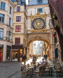 The Gros Horloge a th century astronomical clock installed in a Renaissance arch crossing a medieval street in Rouen Normandy France