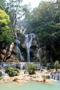 The Kuang Si Falls or Kuang Xi Falls alternatively known as the Tat Kuang Si Waterfalls is a three-tiered waterfall about  kilometers south of Luang Prabang