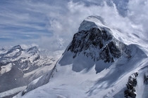The lesser known peak of Breithorn above Zermatt Switzerland The clouds rolling over created a dramatic scene especially for the climbers on top look closely 