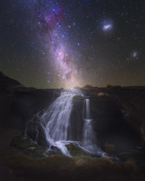 The Milky Way above a small creek with running water in the dark southern skies of Chiles Atacama desert 
