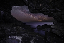 The Milky Way rising over the Atlantic seen from the inside of a sea cave Maine 