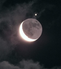 The Moon with Jupiter and  of its moons in the background
