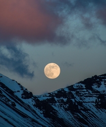 The moonrise above a summit in Iceland while the clouds are red from the sunset in the other direction  - more of my landscape at insta glacionaut