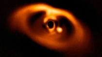 The st clear image of a planet caught in the act of formation The star PDS  is blacked out at the center of the image while the planet PDS b is visible as a bright dot to its right Credit ESOA Mller et al