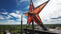 The star on the roof of one of the buildings of an abandoned Soviet factory