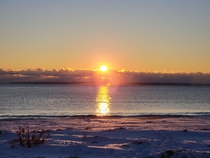 The Sun Rising Over a Snow Covered Beach On the North Shore of Massachusetts 