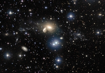 The surroundings of the interacting galaxy NGC  