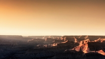The warm glow of the setting sun shines down into the Grand Canyon - Arizona USA 