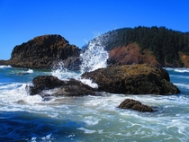 The water splashes up against the rocks perfectly at Cannon Beach in Ecola Sate Park Oregon 