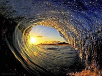 The wave and the sun in the ocean x