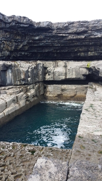 The Worm Hole Aran Island Ireland this is a natural formation also home to the red bull cliff diving championship at one point in time 