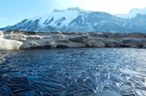 This crazy frozen pond in Switzerland