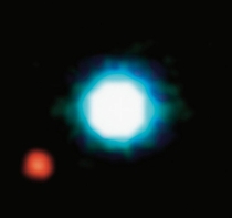 This image shows an exoplanet the red spot on the lower left orbiting the brown dwarf M centre Mb is the first exoplanet directly imaged and the first discovered orbiting a brown dwarf