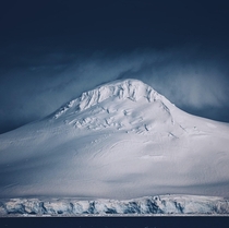 This mountain completely encased in ice completely skews the scale of how big it is From the Antarctic peninsula 